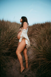 Maternity Photographer, pregnant woman standing in tall grass in the oregon coast area