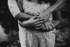detail photo of mom holding daughter's hand