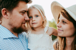mom, dad and toddler looking at each other during family session in portland oregon