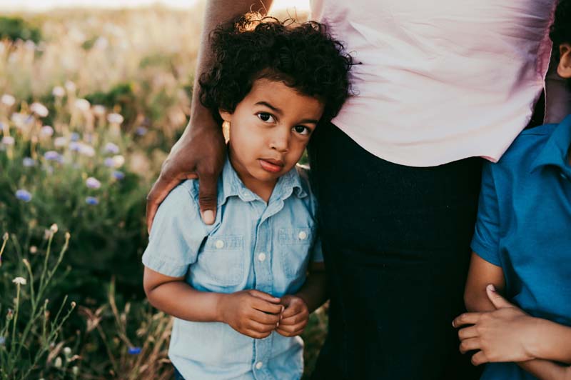 boy looks directly at camera during family photo session in portland