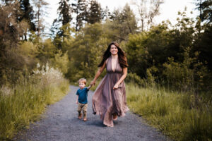 boy running at a park with is mom during photoshoot for beaverton toy stores