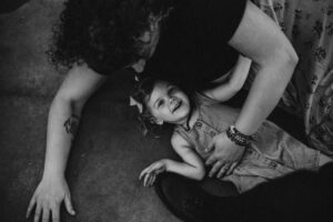 mother and daughter sitting on the floor during photoshoot for birthday party ideas in Portland