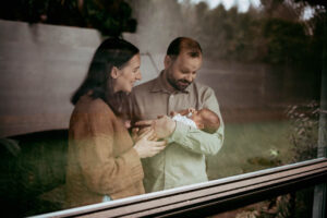 mom dad and baby at home during newborn photography portland
