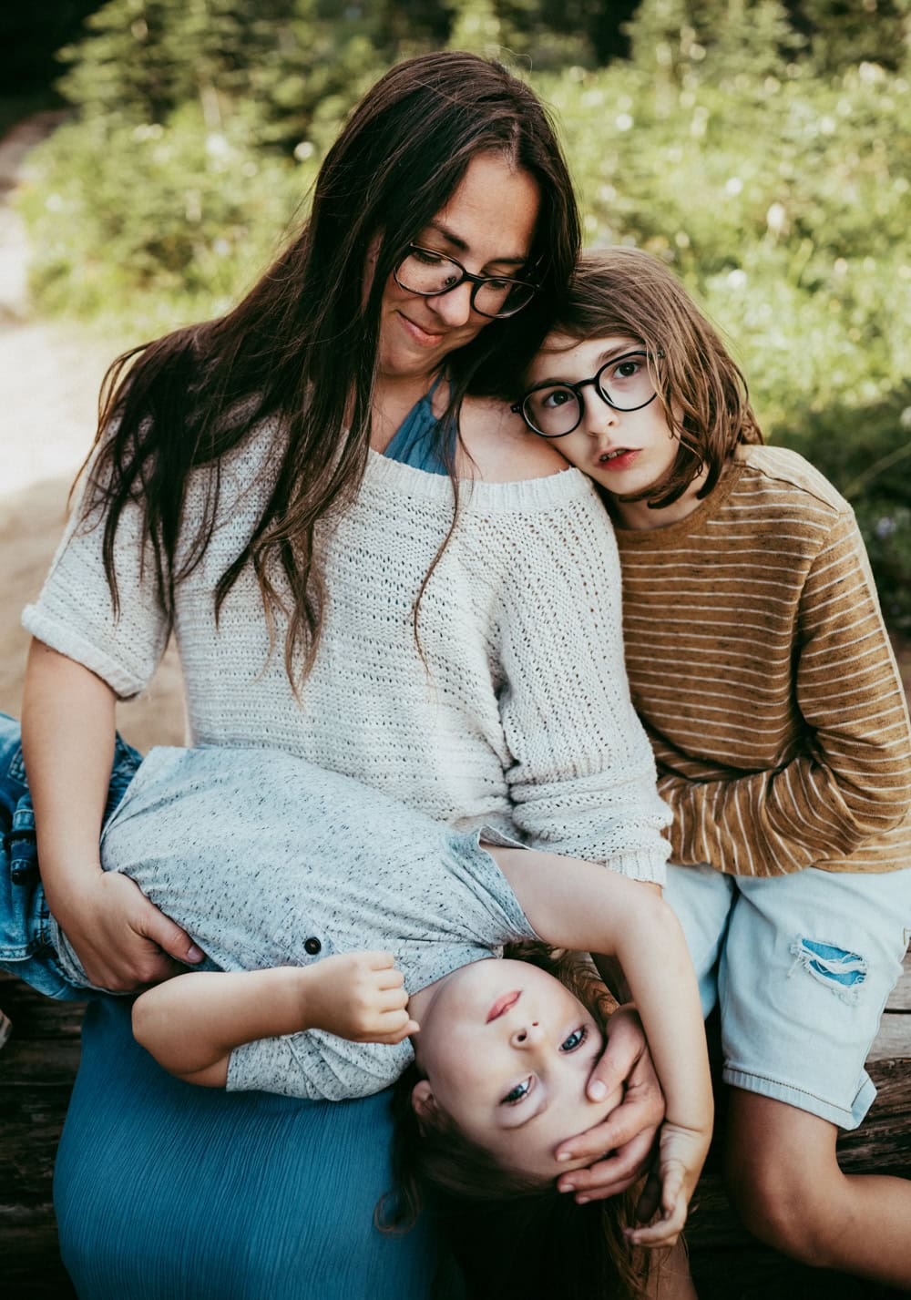 mom and two sons sitting together during mt rainier family photos