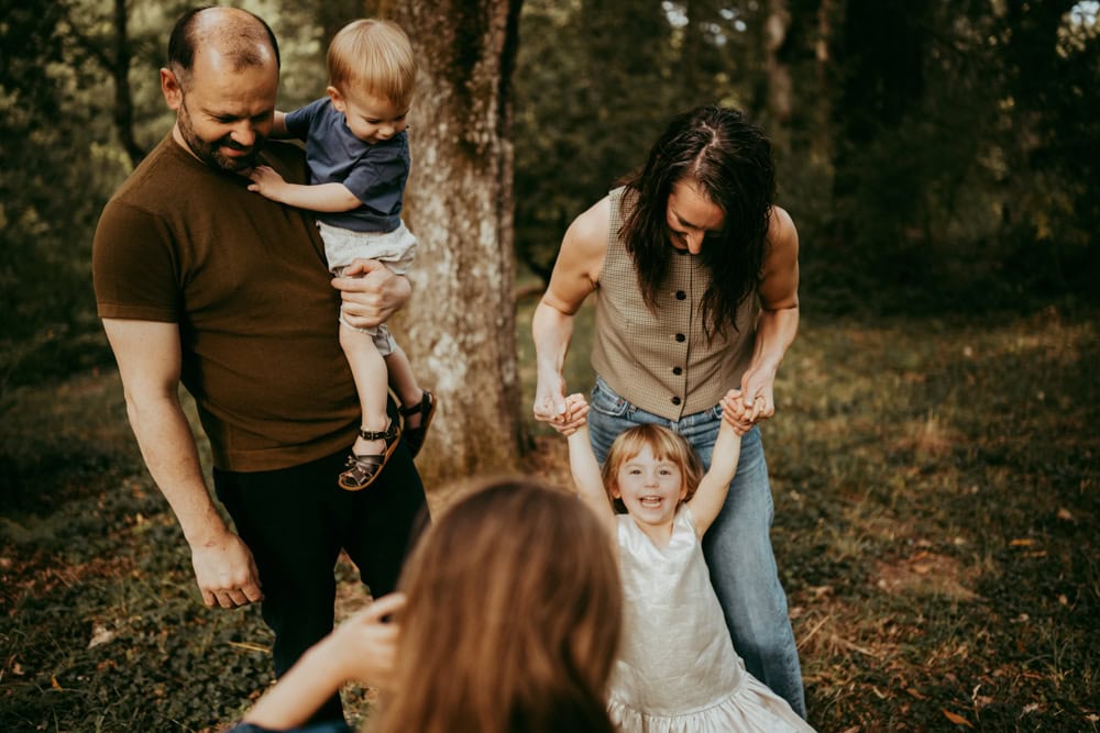 family playing at the park wearing complimentary clothing