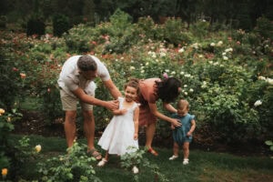 family of mom, dad and two girls at the international rose test garden