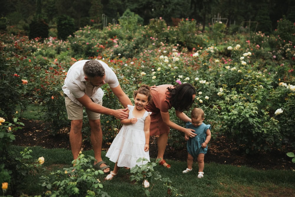 family of mom, dad and two girls at the international rose test garden